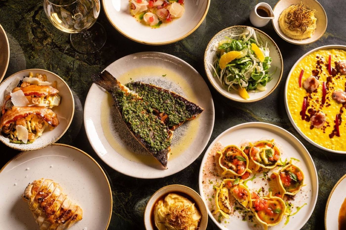 A table spread of dishes at La Bottega Linka
