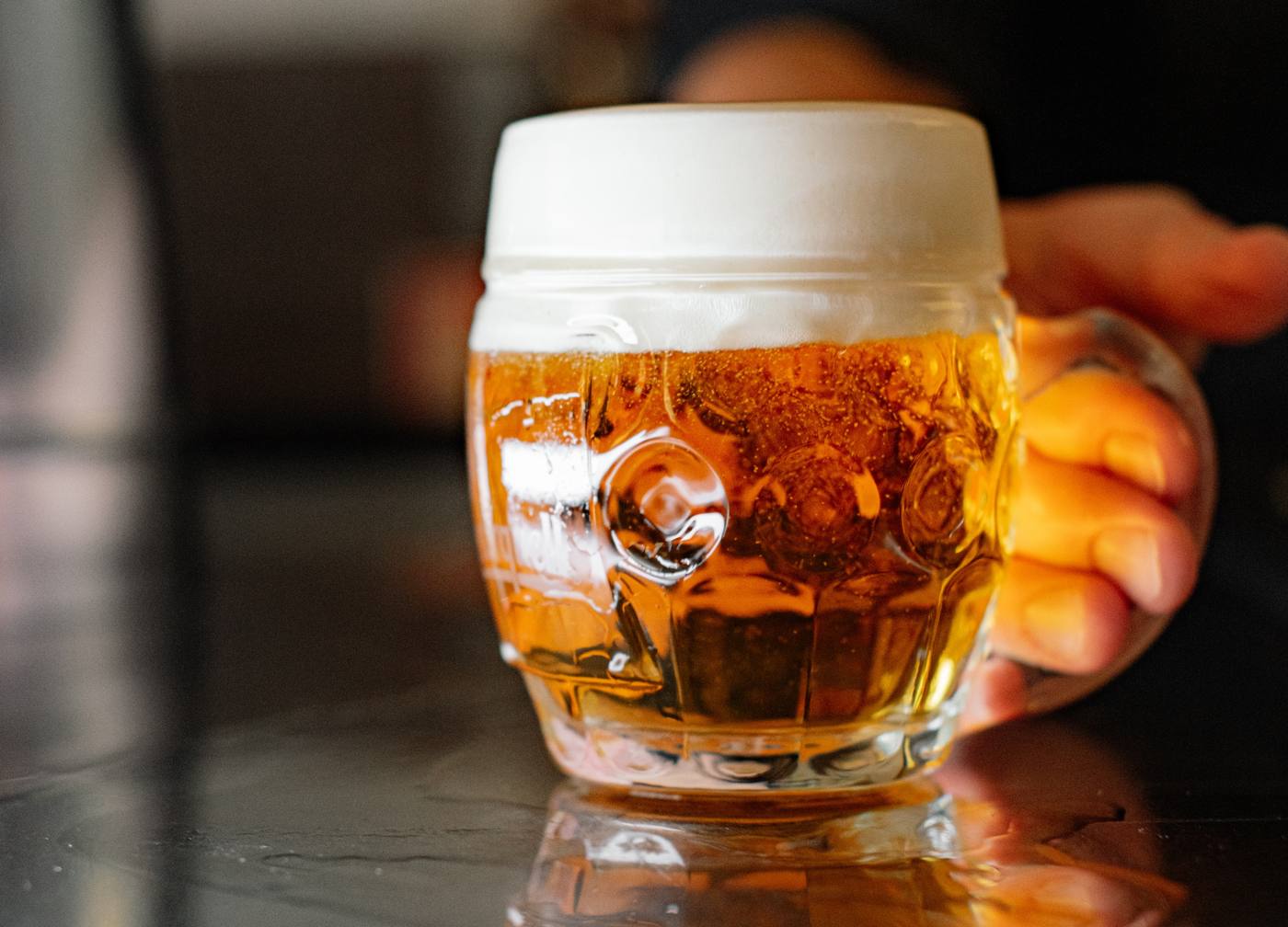 A freshly poured mug of tank beer with a thick head of foam