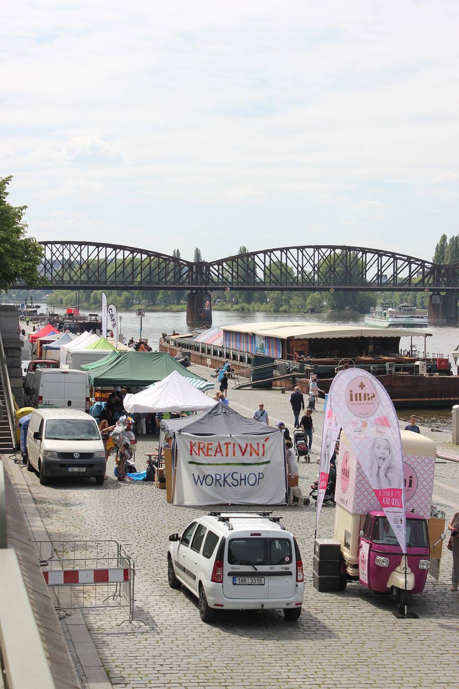 Stalls on Rašínovo nábřeží with the Vyšehrad railway bridge in the background