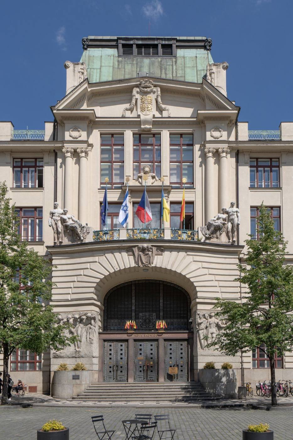 The art nouveau facade of the New Town Hall on Mariánské náměstí with its sculptures and flags