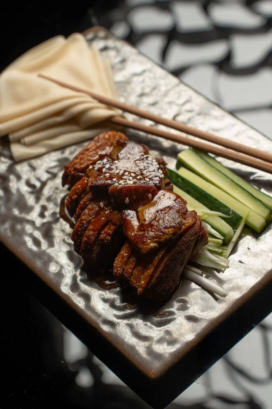 Glazed stone-oven crispy duck with pancakes, cucumber and spring onion
