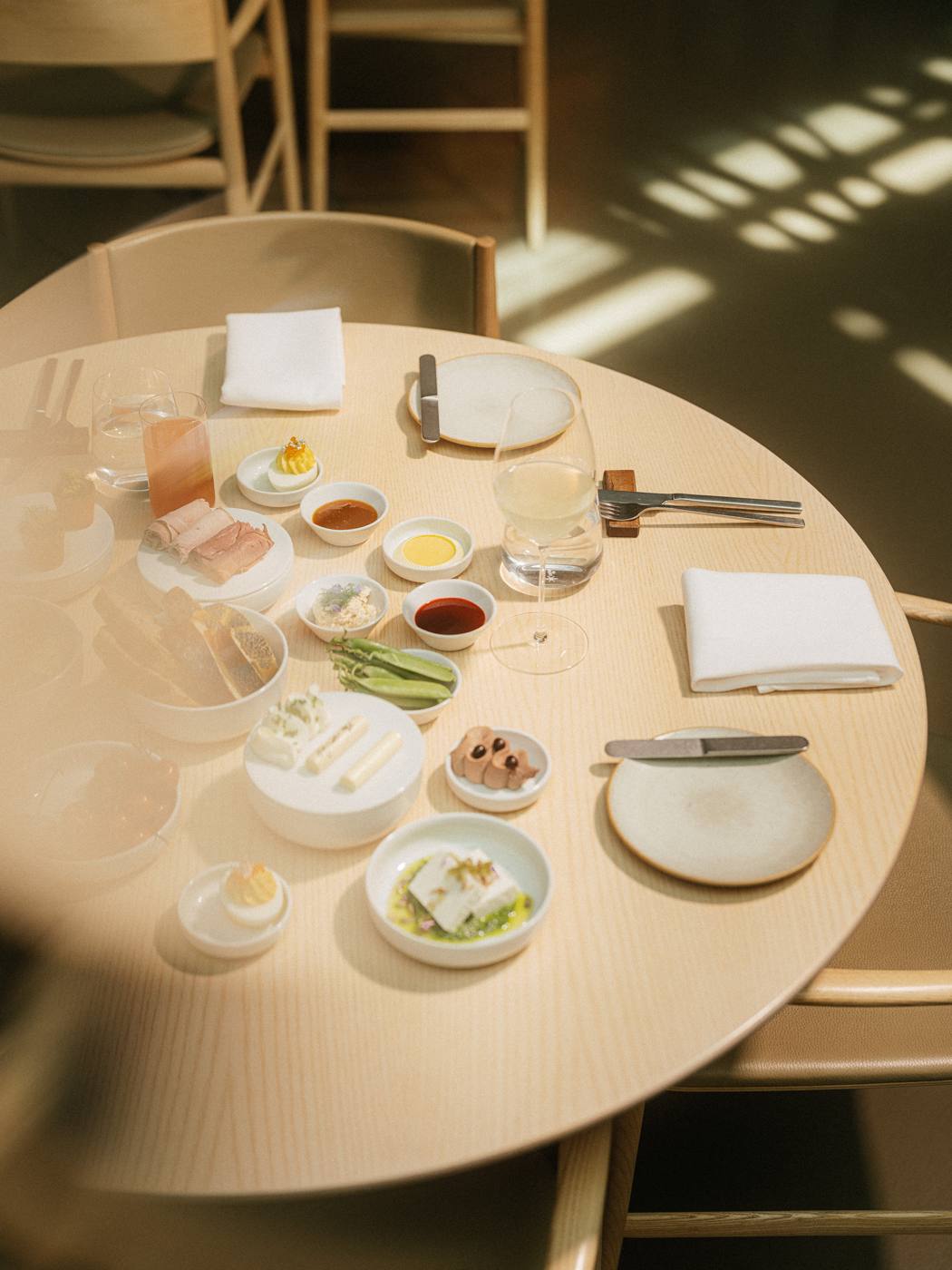 Round table set with small shared plates for the Saturday breakfast tasting