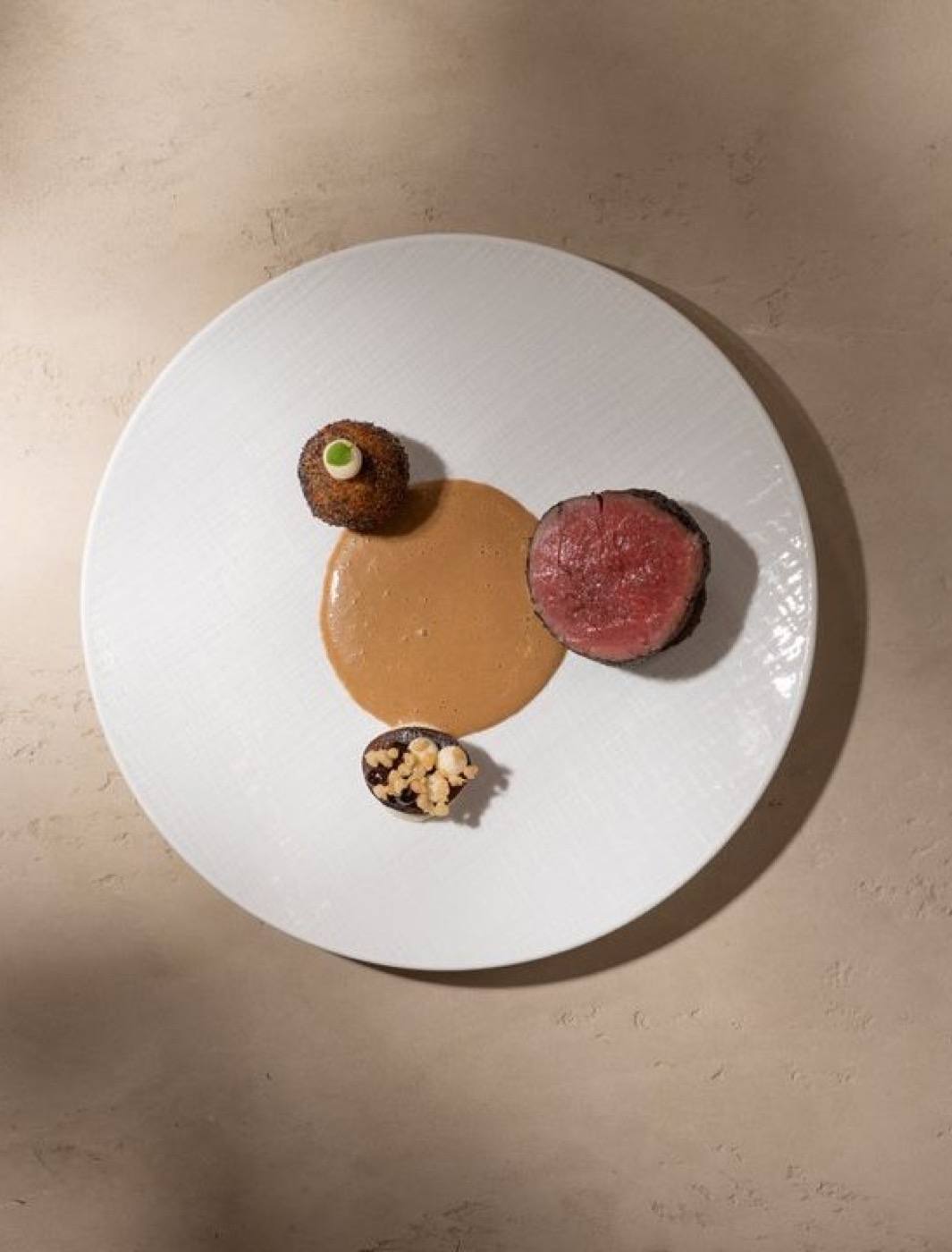 A modern take on beef svíčková: beef tenderloin, cream sauce, plum and a poppy-seed potato dumpling