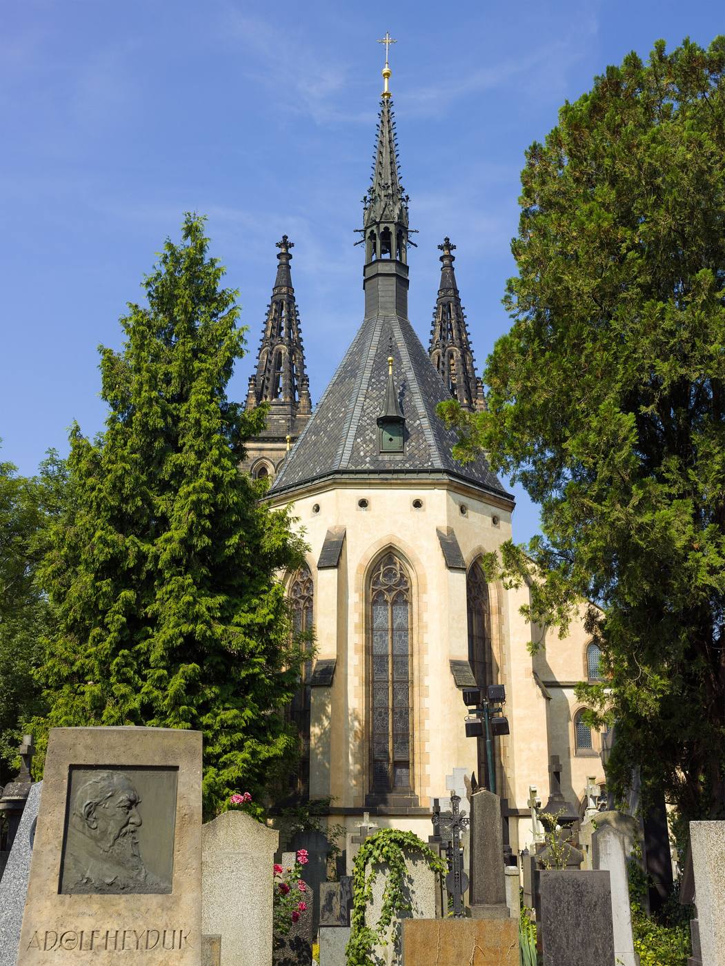 The neo-Gothic spires of the Basilica of Sts Peter and Paul rising above graves in Vyšehrad Cemetery